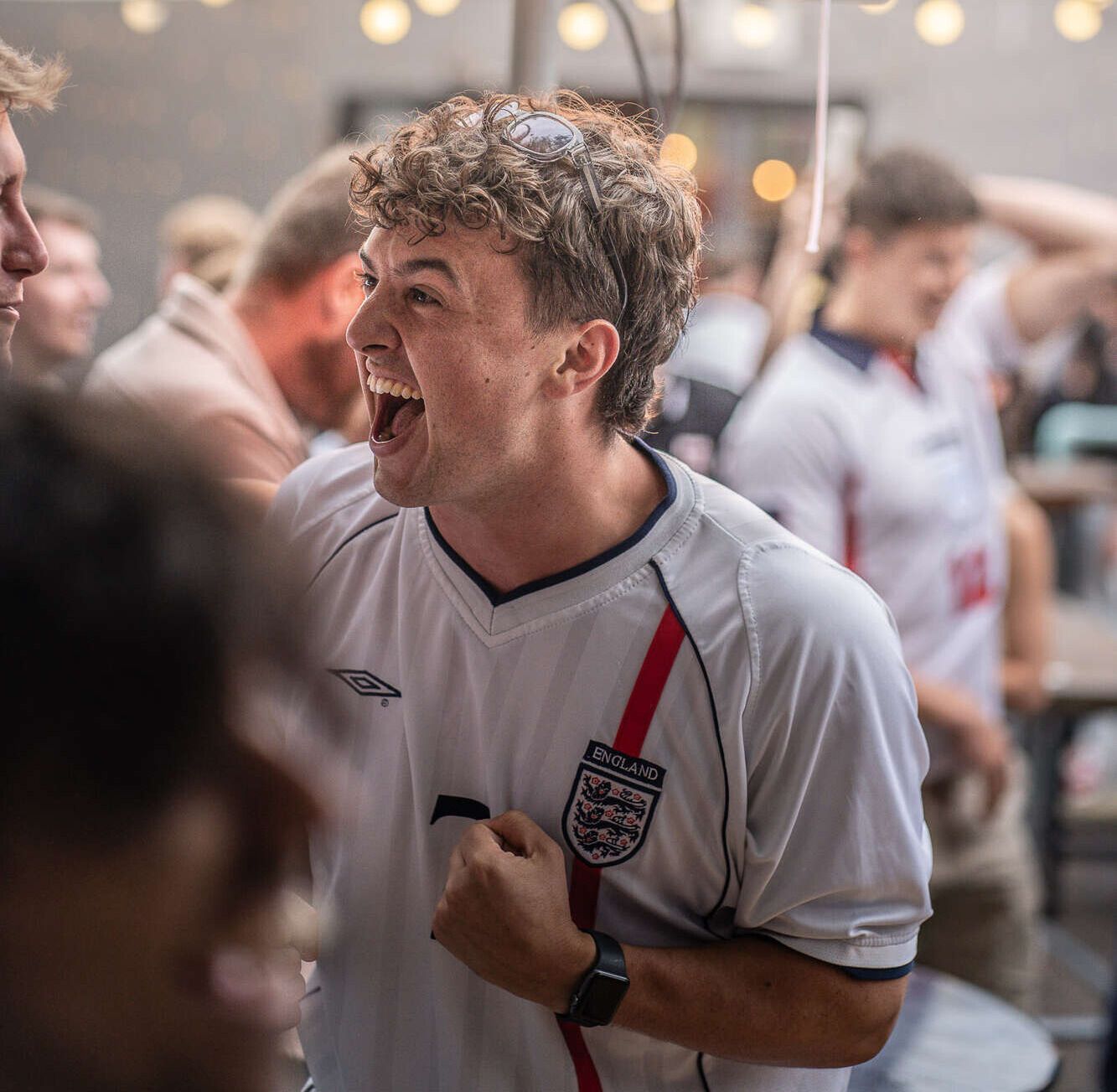 Man cheering with football shirt on