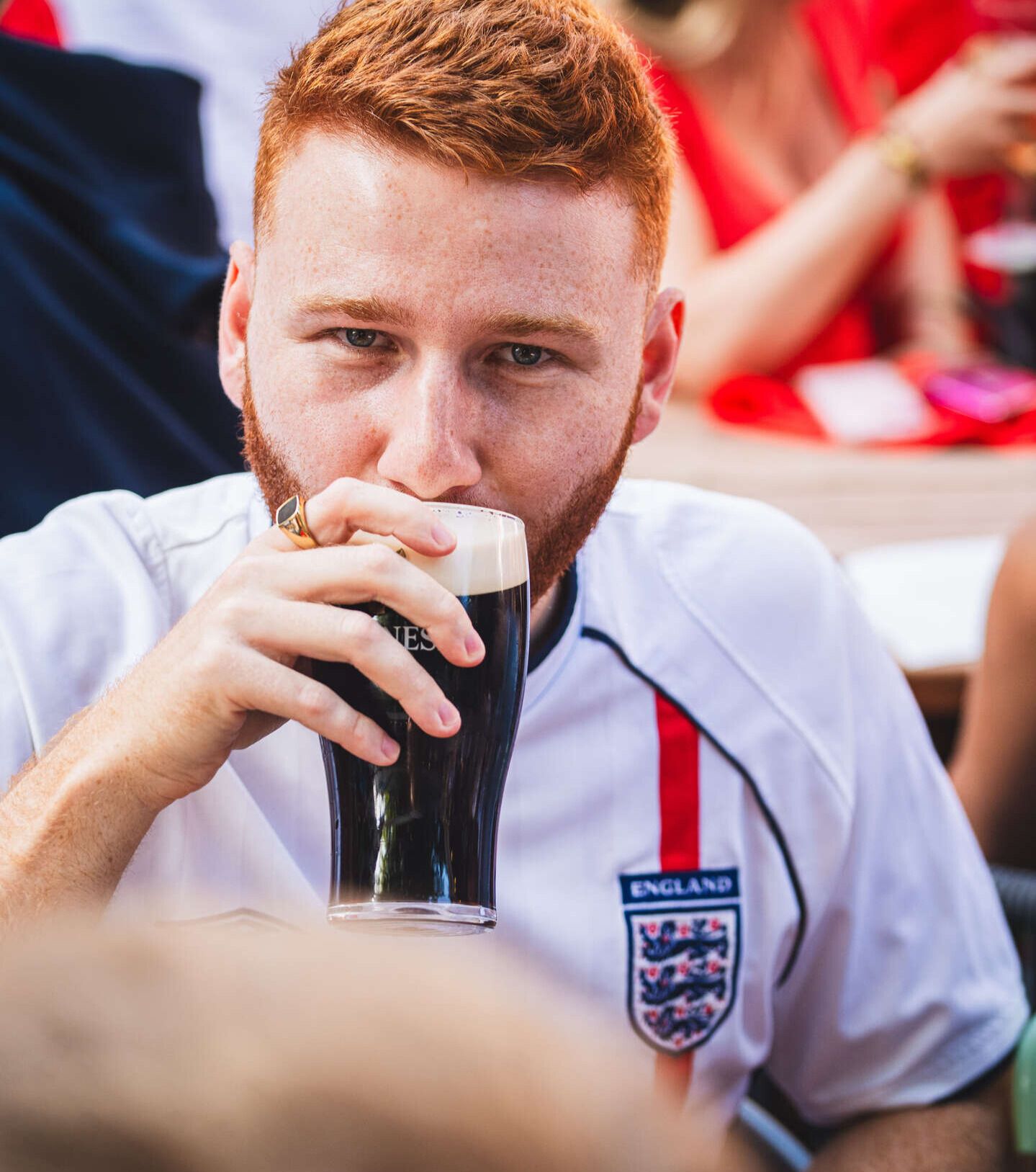 Football fan drinking a pint