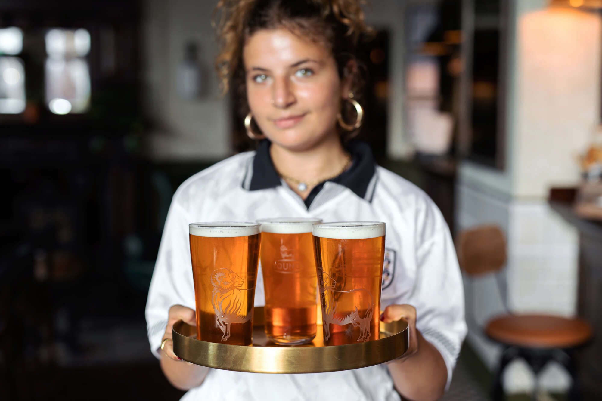 Woman holding pints to serve